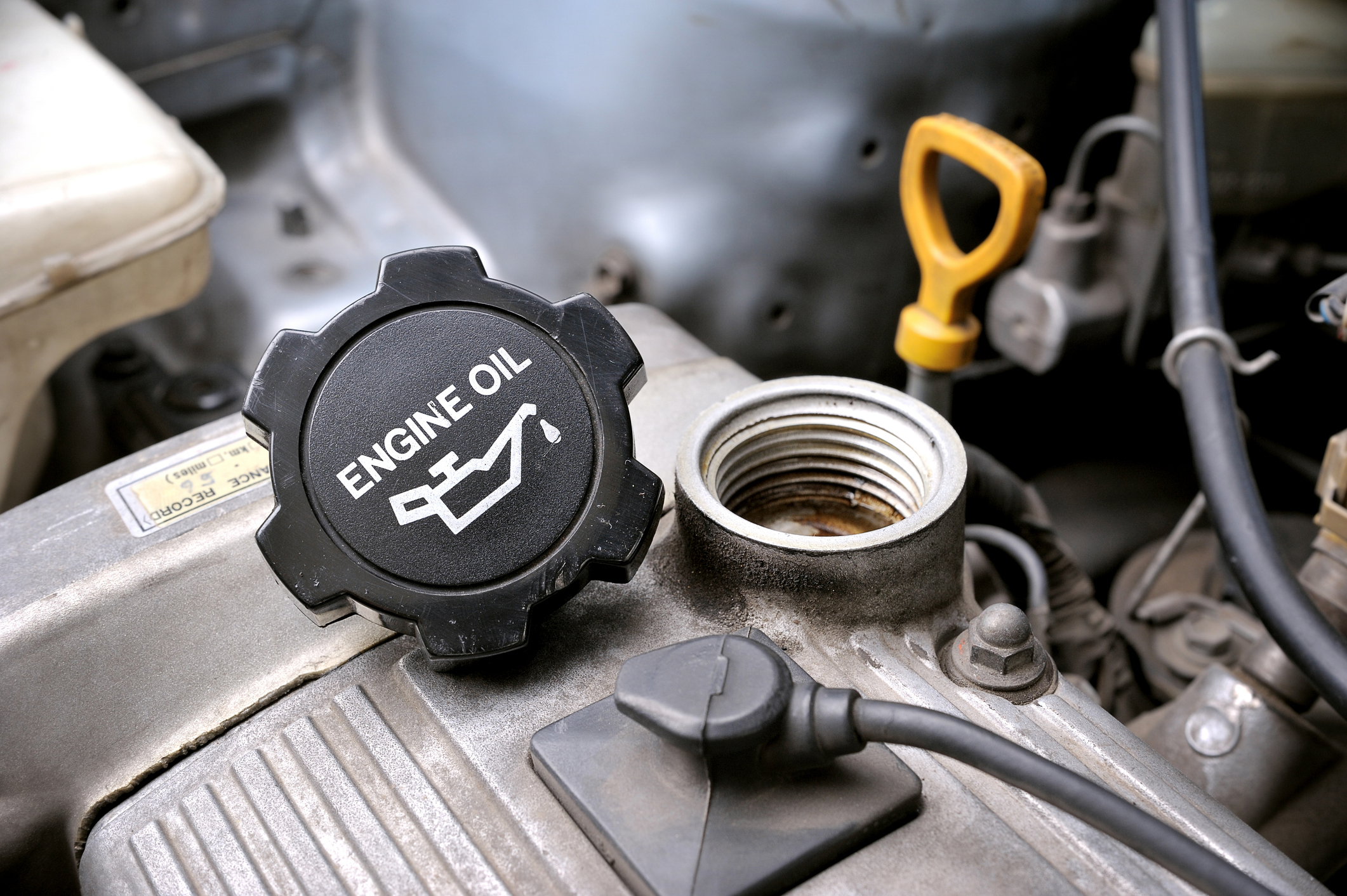 An oil cap for an engine that has been taken off.